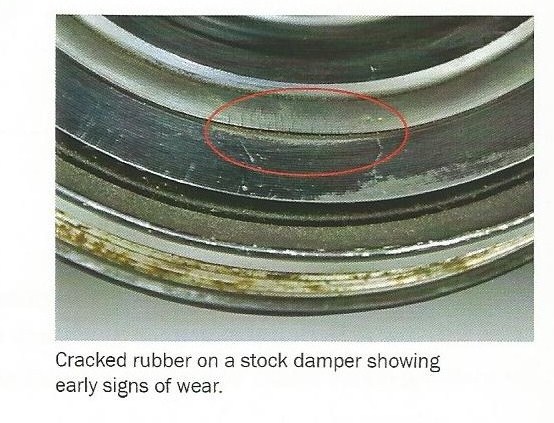 Cracked rubber on a stock damper showing early signs of wear